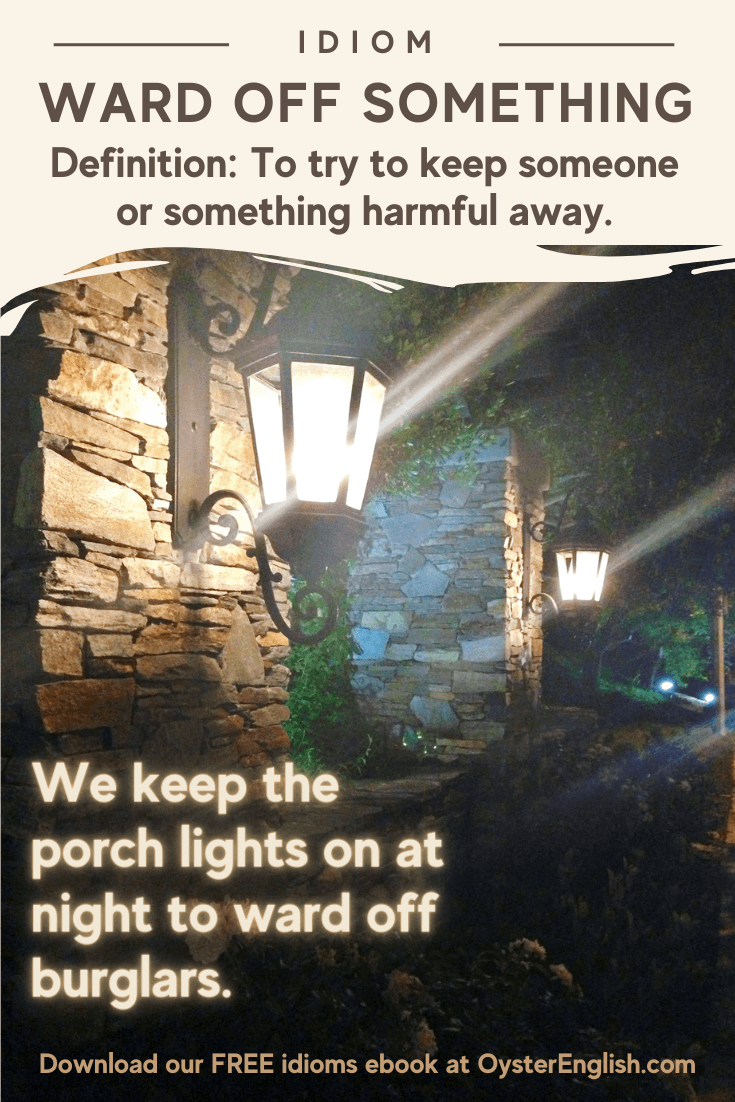 Image of a house with porch lights on at night: We keep our porch lights on at night to ward off burglars.