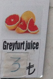 Close up of the fruit stand sign of misspelled juices: greyfurt juice.