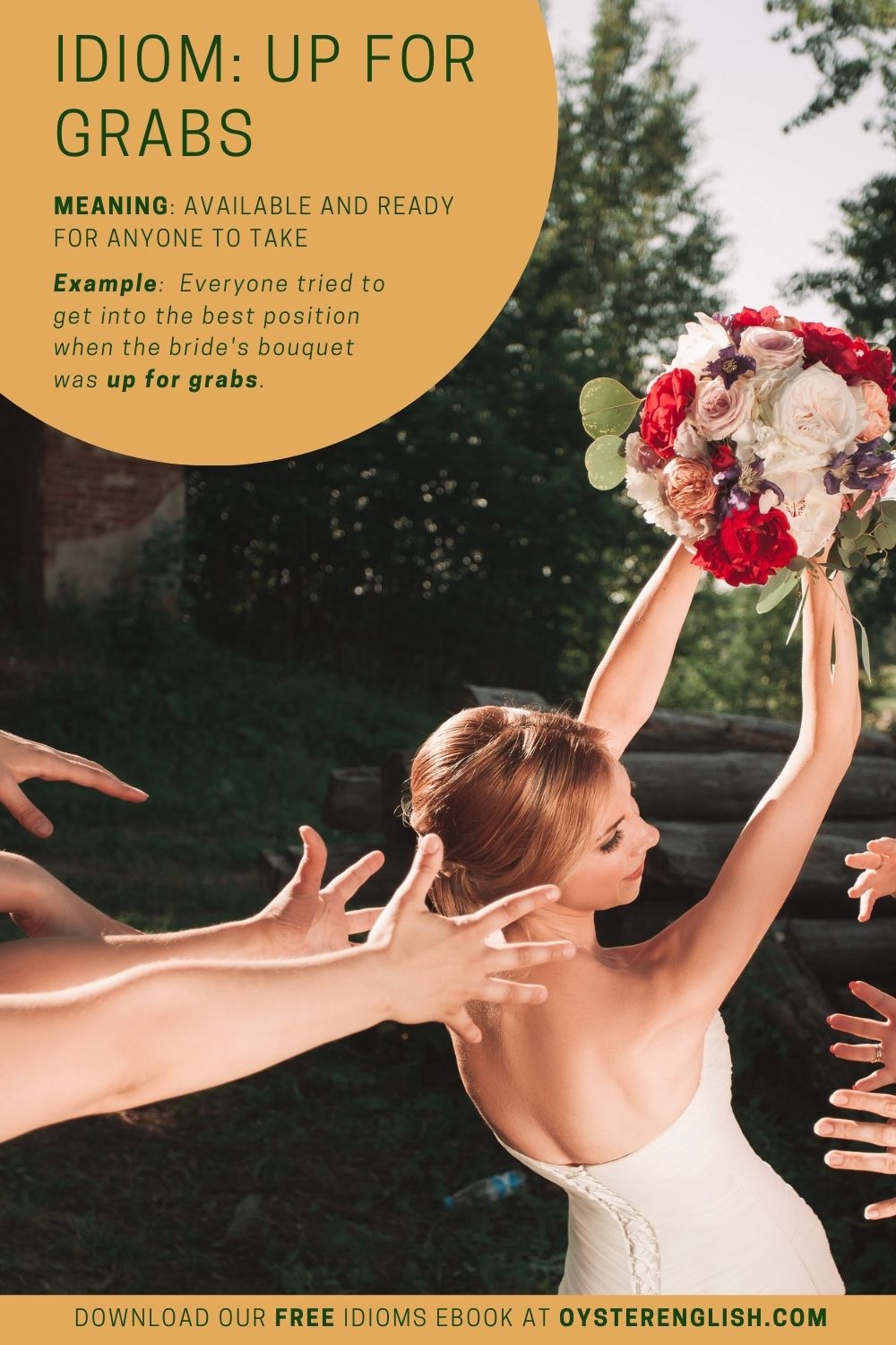The bride holds her bouquet in the air and the wedding guests' hands are stretched out, ready to catch it. "Everyone tried to get in the best position when the bride's bouquet was up for grabs."