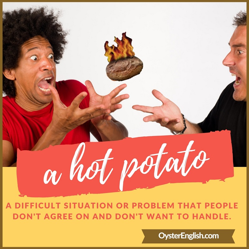 A picture of a "hot" flaming potato between to men who are afraid to catch it plus the definition of a hot potato.