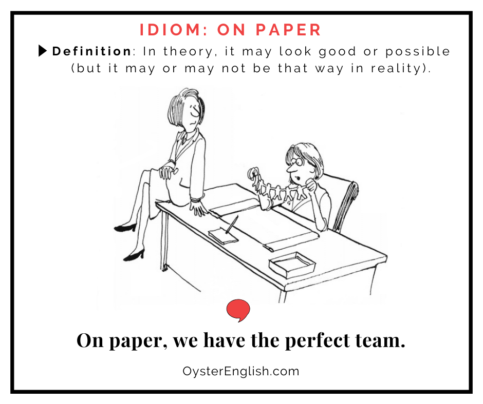 A cartoon businesswoman sits at a desk holding up a chain of connecting paper cutout people. She laments to her colleague: On paper, we have the perfect team. The definition of the idiom "on paper".